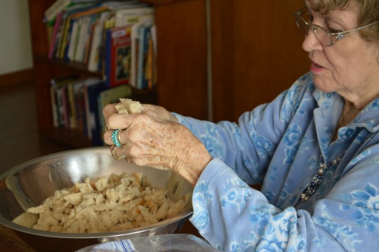 Granny tearing up the bread for the dressing