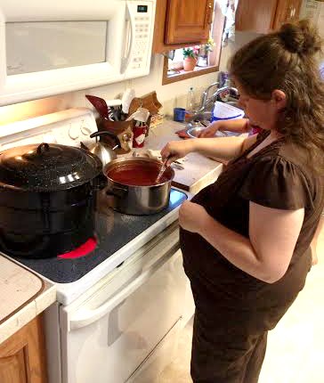 Stirring Plum Jelly at 24 weeks pregnant | RaisingArrows.net
