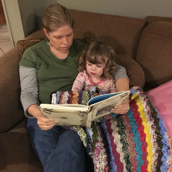 Reading aloud from Brambly Hedge to the 2 yo. during this week's Large Family Homeschooling Week in Review